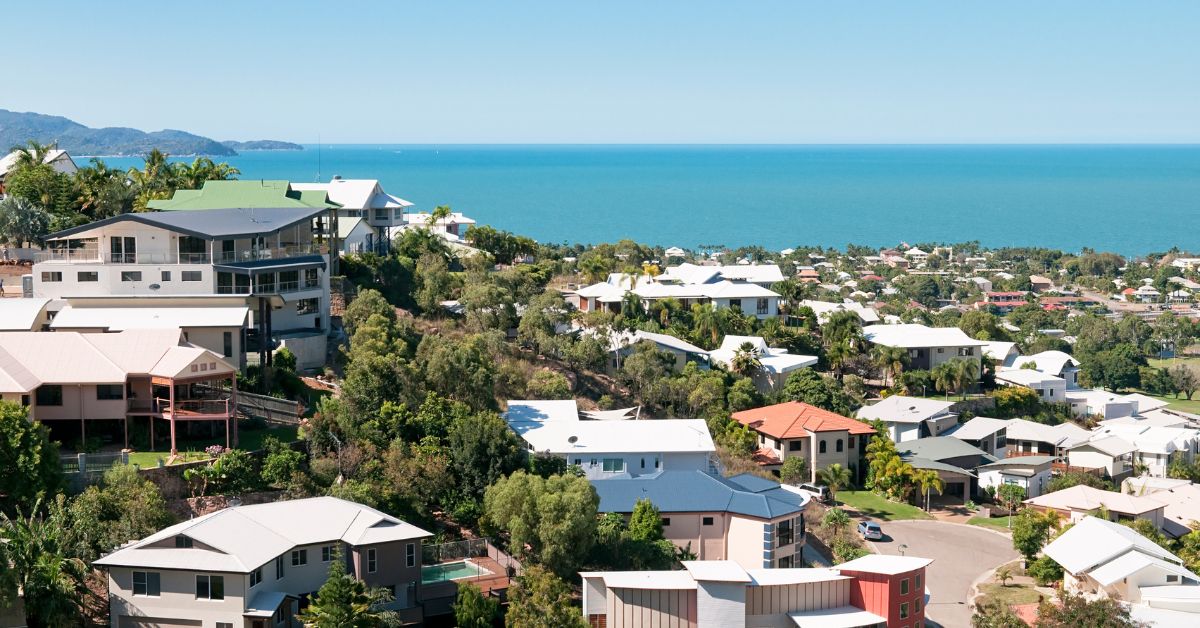 Urban coastal neighborhood with modern homes and ocean view, representing factors considered in urban property appraisals