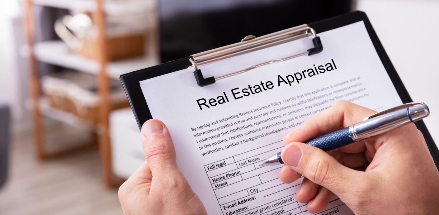 Bound commercial appraisal report open on a desk