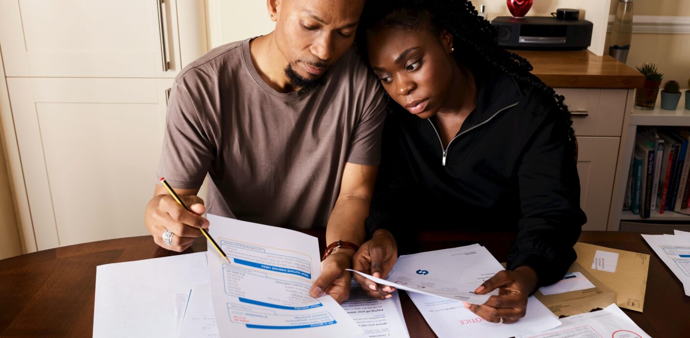 Executor reviewing estate paperwork and house keys before ordering a date of death appraisal