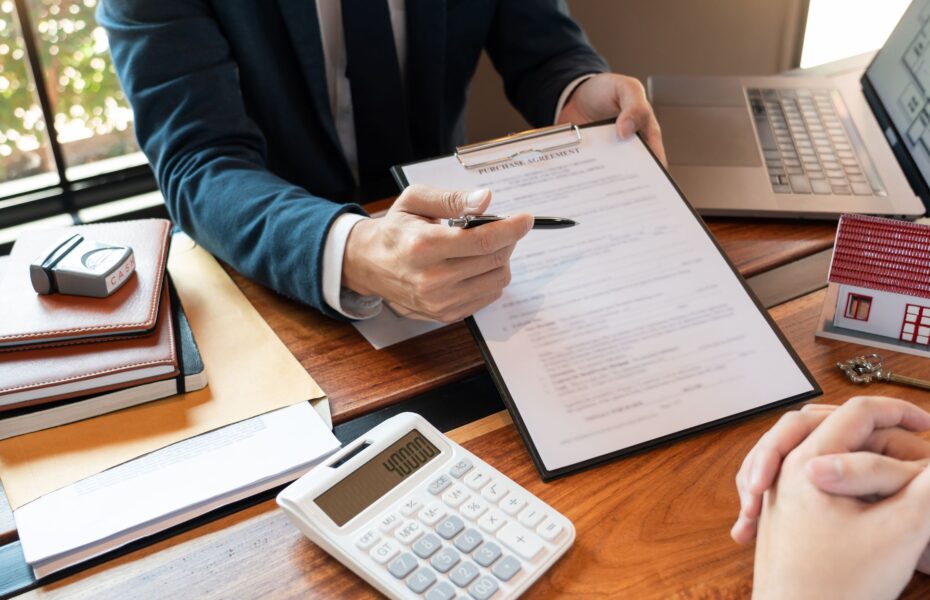 Loan officer reviewing a commercial appraisal for lending at a bank office desk.