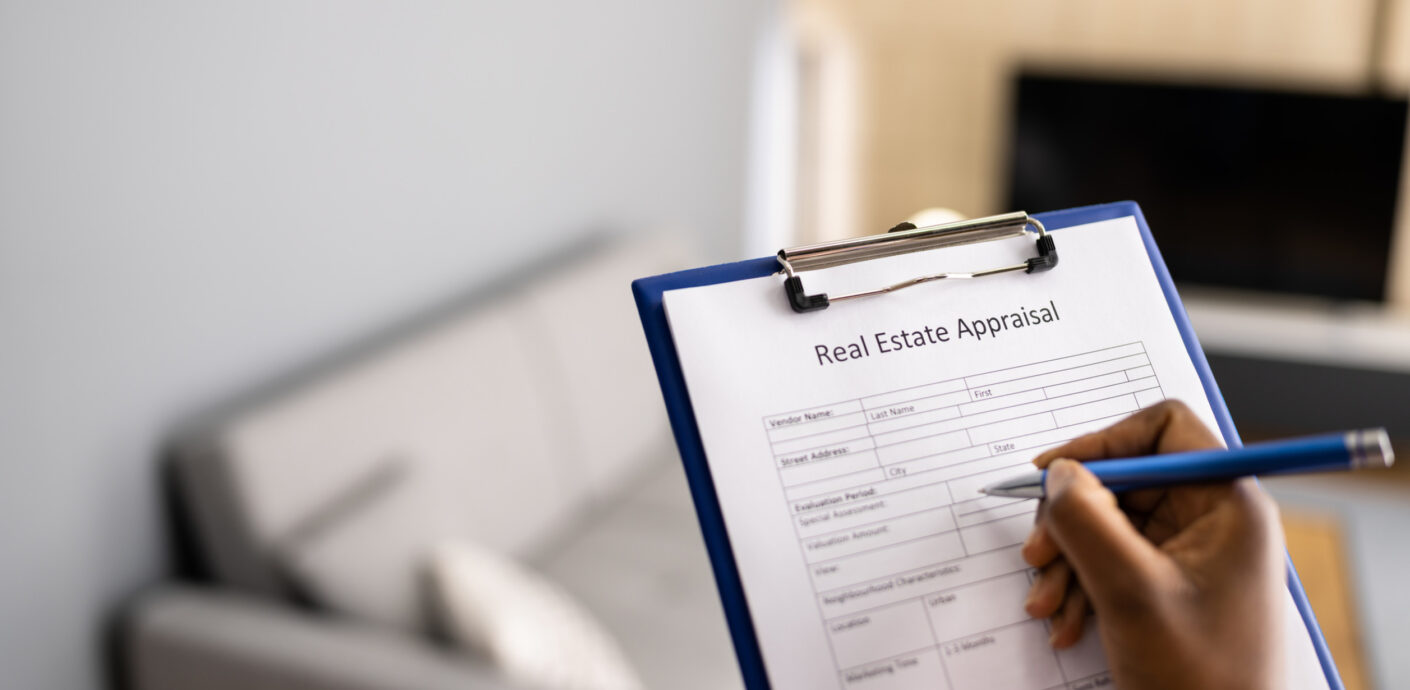 Appraiser filling up an appraial report of a Chicago brick home during a home appraisal